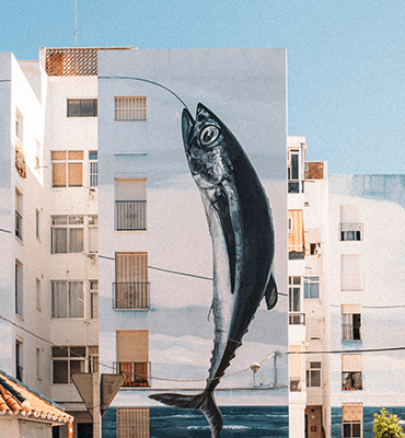 Tall vertical fish mural on building